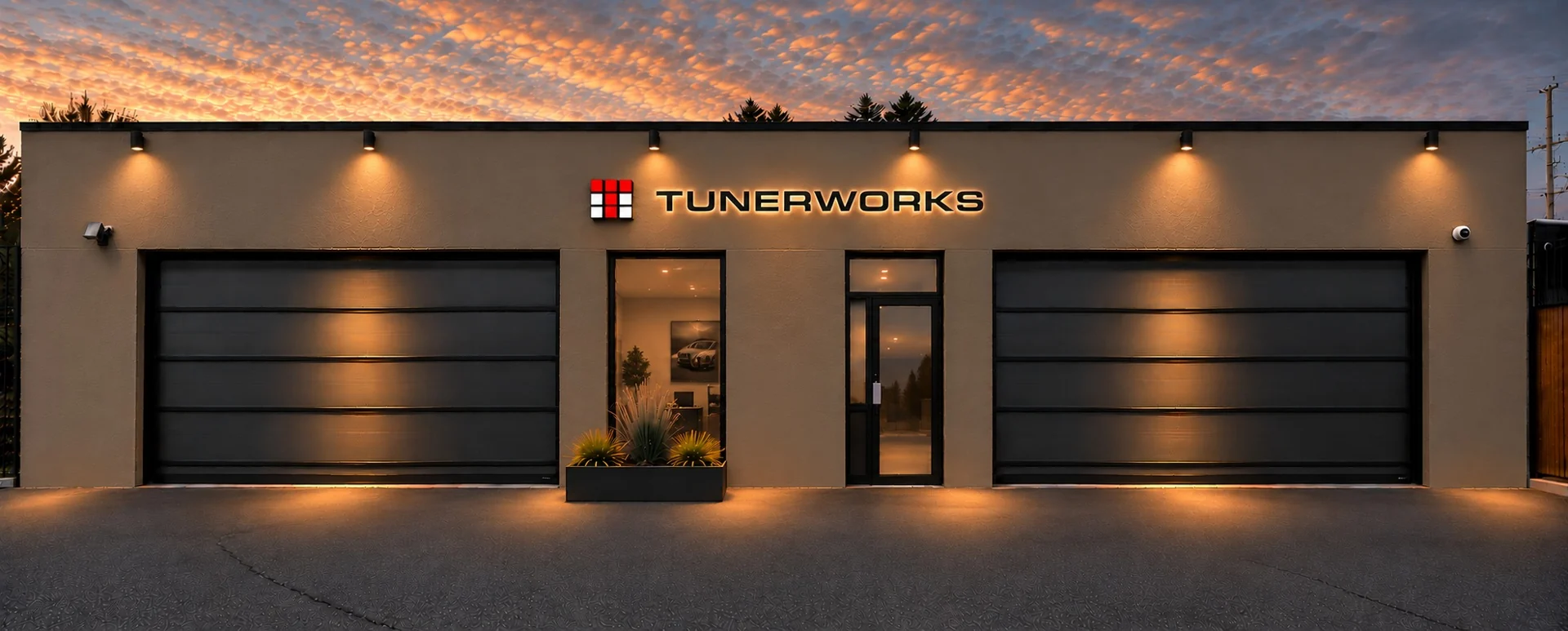 Rendering of the new Tunerworks showroom exterior with illuminated signage at sunset